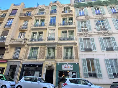 a large building with cars parked in front of it at Nice Centre Flat - Modern, Quiet and Brand New in Nice