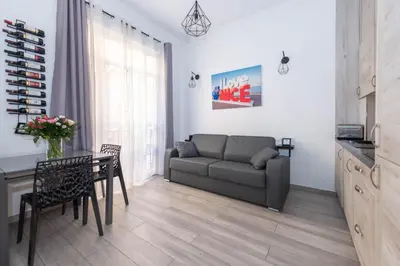 a living room with a couch and a table at Nice Centre Flat - Modern, Quiet and Brand New in Nice