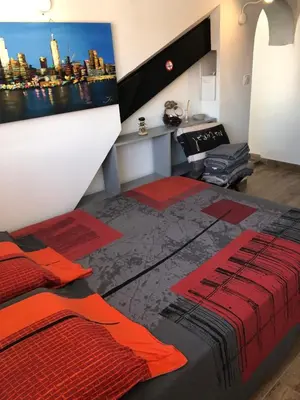 a bedroom with a bed and a wall with a tv at F2 Centre - Gare in Nice