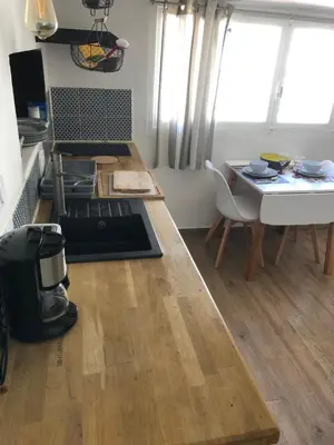 a kitchen with a table and a table and a dining room at F2 Centre - Gare in Nice