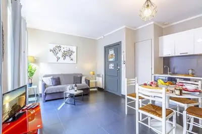 a kitchen and a living room with a table and a couch at MY CASA - PARADIS - Carré d Or 1 room - Balcony Sea View in Nice