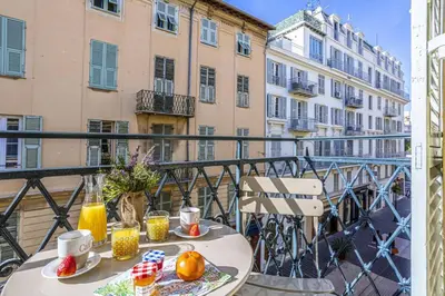 a table with food and drinks on a balcony at MY CASA - PARADIS - Carré d Or 1 room - Balcony Sea View in Nice