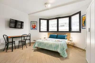 a bedroom with a bed and a table and chairs at Les Oranges Five Stars HolidayHouse in Nice