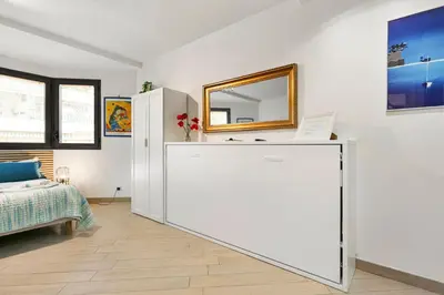 a room with a large white refrigerator and a bed at Les Oranges Five Stars HolidayHouse in Nice