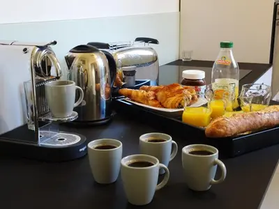 a table topped with cups of coffee and croissants at 