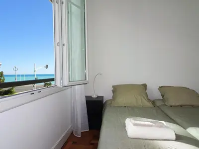 a bedroom with a bed and a window with the ocean at 