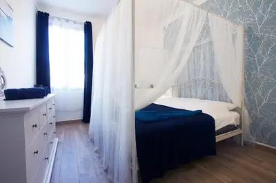 a bedroom with a bed with a mosquito net at 