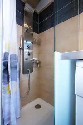 a bathroom with a shower with a sink and a toilet at 