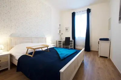 a bedroom with a bed and a desk and a window at 