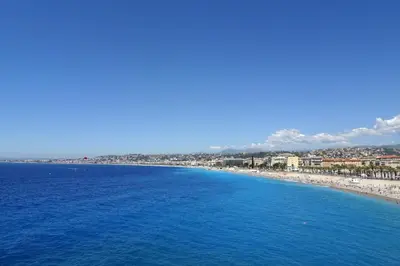 a view of a beach with the ocean and buildings at 