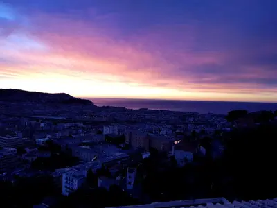 a view of a city at sunset at Maison / Appart Le PIOL in Nice