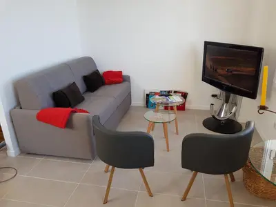 a living room with a couch and two chairs and a tv at Maison / Appart Le PIOL in Nice