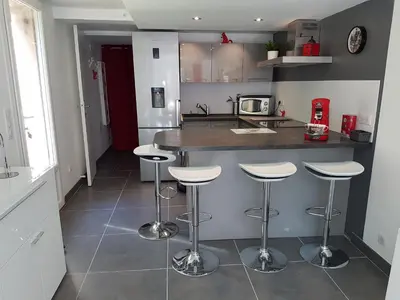 a kitchen with a counter and bar stools at Mikado in La Gaude