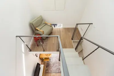 a living room with a chair and stairs at Residence Tonduti in Nice