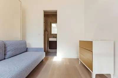 a living room with a bed and a dresser at Residence Tonduti in Nice