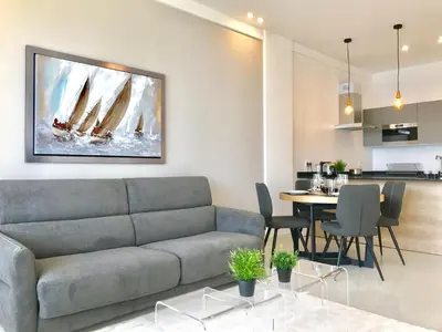 a living room with a couch and a table at Florida Blue - Easy Home Booking in Nice