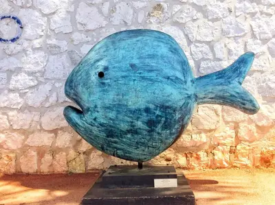 a blue dolphin statue in front of a wall at Villa du Cros in Cagnes-sur-Mer