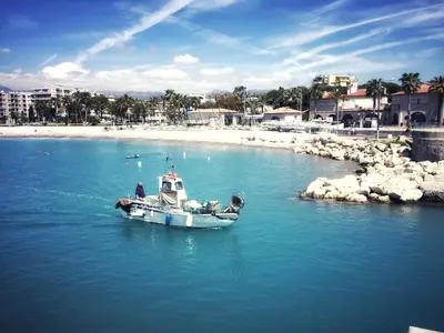 a small boat in the water near a beach at Villa du Cros in Cagnes-sur-Mer