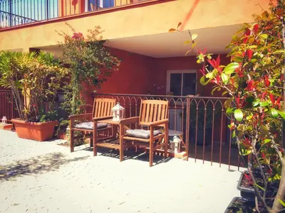 two chairs and a table on a porch at Villa du Cros in Cagnes-sur-Mer
