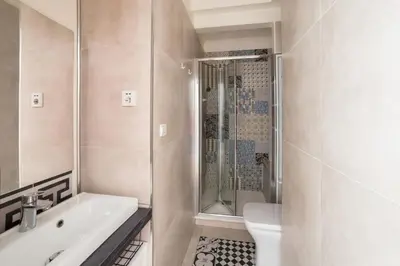 a bathroom with a shower and a sink at Studio Guiglia - Welkeys in Nice
