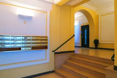 a hallway of a building with stairs and an archway at Nestor&Jeeves - TROIS PROMENADE - Central - Very close sea in Nice