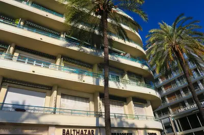 a building with palm trees in front of it at Nestor&Jeeves - TROIS PROMENADE - Central - Very close sea in Nice
