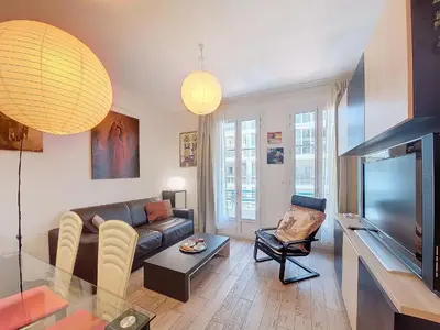 a living room with a couch and a television at Nestor&Jeeves - TROIS PROMENADE - Central - Very close sea in Nice