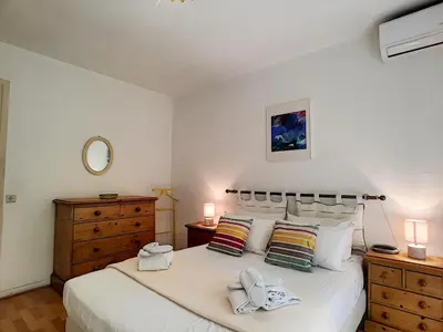 a bedroom with a large white bed and a dresser at Nestor&Jeeves - MARIN DEBUSSY - Central - By shopping area in Nice