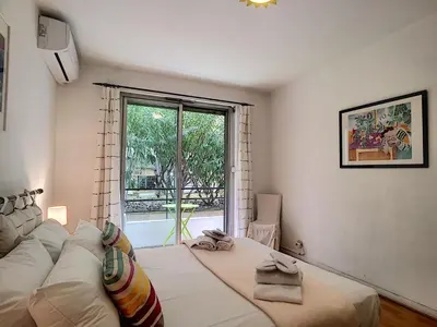 a bedroom with a large white bed and a window at Nestor&Jeeves - MARIN DEBUSSY - Central - By shopping area in Nice