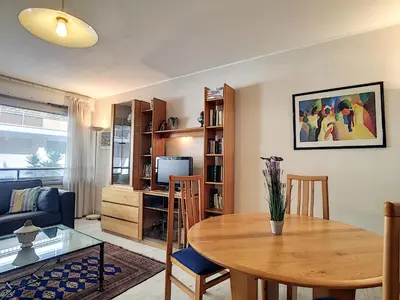 a living room with a table and a couch at Nestor&Jeeves - MARIN DEBUSSY - Central - By shopping area in Nice