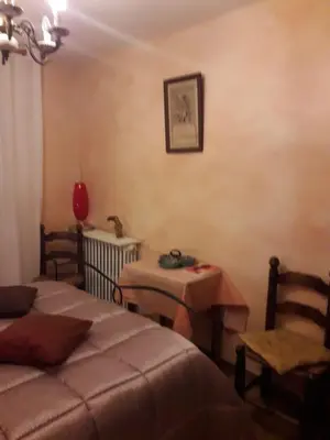 a room with two beds and a table and a chair at Chambre chez l’habitant chez Nadine in Cagnes-sur-Mer