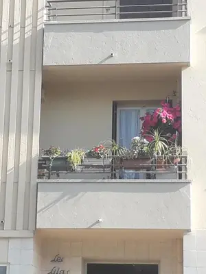 a balcony with potted plants on a building at Chambre chez l’habitant chez Nadine in Cagnes-sur-Mer