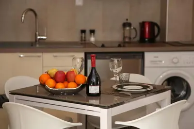 a table with a bowl of fruit and a bottle of wine at Stylish 2 Room Flat 60 meters to the beach in Nice