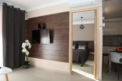 a sliding mirror in a room with a bedroom at Stylish 2 Room Flat 60 meters to the beach in Nice