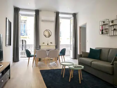a living room with a couch and a table and chairs at Appartement Urban 3 in Nice