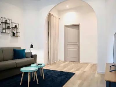 a living room with a couch and a table at Appartement Urban 3 in Nice
