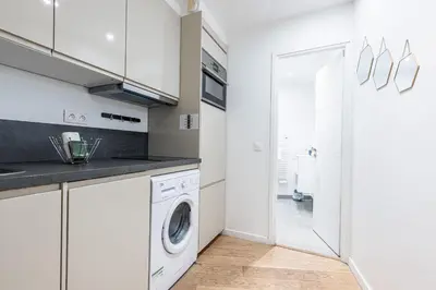 a white kitchen with a washer and dryer at Quiet and cosy 1bdr in Vieux Nice! in Nice