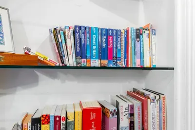 a bunch of books sitting on a shelf at PREF 2 · F4 - VASTE ET BOURGEOIS ,3 CHAMBRES, ASCENSEUR, VX-NICE in Nice