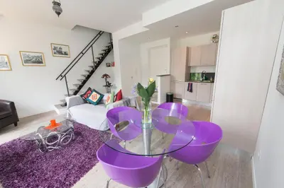 a living room with a purple table and a purple rug at La Garibaldi in Nice