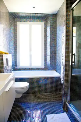 a bathroom with a tub and a toilet and a window at La Garibaldi in Nice
