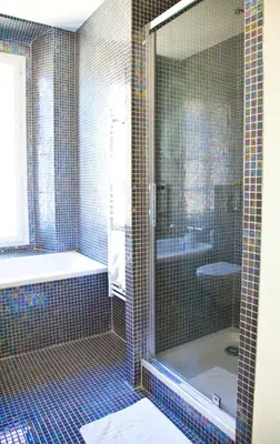 a bathroom with a shower and a tub and a toilet at La Garibaldi in Nice