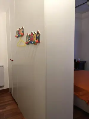 a white wall with three toy houses on it at Irene Apartment in Nice