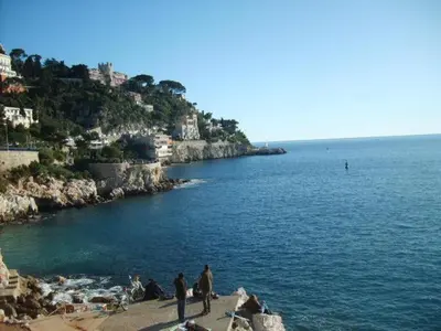 a group of people on a beach near the water at Appartement Nice Port in Nice