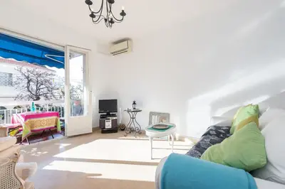 a living room with a couch and a table at Appartement Nice Port in Nice