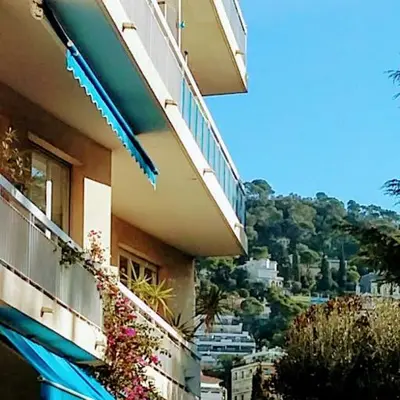a building with a balcony with a view of a city at Appartement Nice Port in Nice