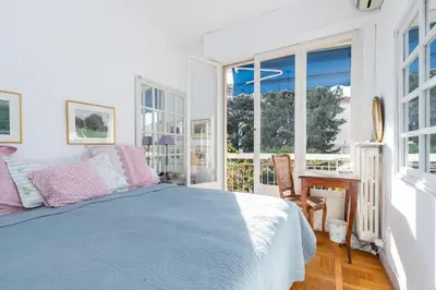 a bedroom with a bed and a desk and windows at Appartement Nice Port in Nice