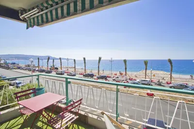 a balcony with chairs and a view of the beach at MILORD PROMENADE 2 - PROMENADE HOLIDAY in Nice