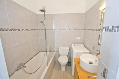 a bathroom with a toilet and a tub and a sink at MILORD PROMENADE 2 - PROMENADE HOLIDAY in Nice