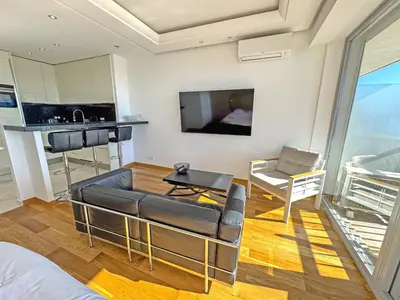 a living room with a couch and a table at CARIATIDES STUDIO - PROMENADE HOLIDAY in Nice