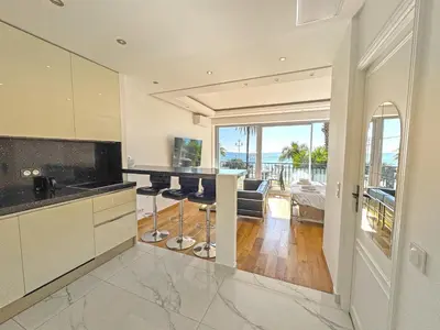 a kitchen with a bar with a view of the ocean at CARIATIDES STUDIO - PROMENADE HOLIDAY in Nice